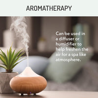 Aromatherapy image showing an essential oil diffuser releasing mist, demonstrating use in a diffuser or humidifier to freshen air and create a spa-like atmosphere.